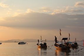 fishing boats on water at dusk