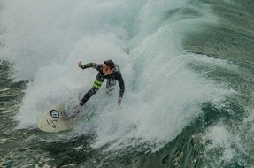 surfer rides in big waves