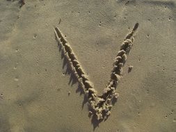 Letter V on the Sand