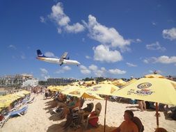 plane over the beach on the island of st maarten