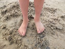 baby feet on the sand by the baltic sea