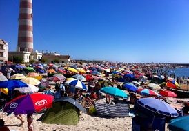 many sun umbrellas on the beach in portugal