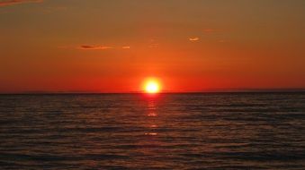 orange sunset on the horizon over the coast of sardinia