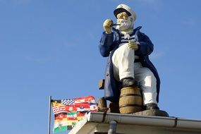sea captain figure on the roof