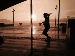 silhouette of a running girl in a storm