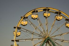 golden ferris wheel in the park at dusk