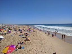 people relax on the beach in Costa da Caparica, Portugal