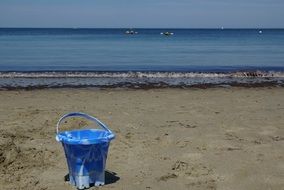 Colorful bucket on the sandy beach