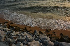 surf on stones at dusk
