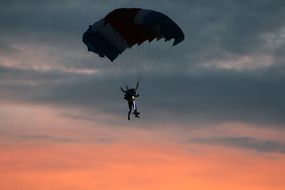 skydiver in the sunset sky