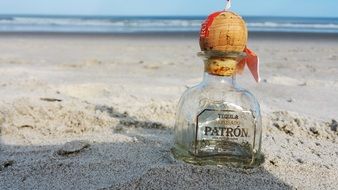 bottle with a letter in the sand