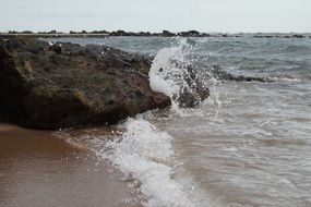 waves splashing on rock on edge of sea