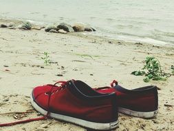 red shoes with laces on the beach
