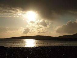the evening sun hides behind the clouds
