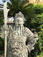 sculpture of a guard in a big Asian palace