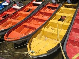 multi-colored rowing boats near the pier