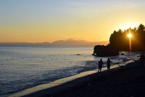 Vacation on a Sand beach at the sunset
