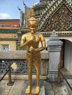 golden statue in a big asian palace