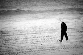 lonely man on a grey beach