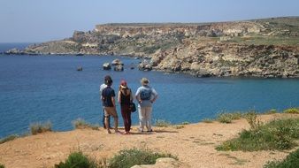 tourists on the coast near gnejna bay