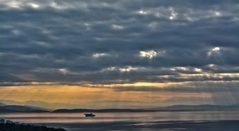 distant view of the ship in the harbor at sunset