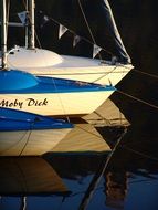 boats reflected in the water at sunset