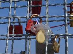locks of lovers and children suck on lattice of Pilsum Lighthouse