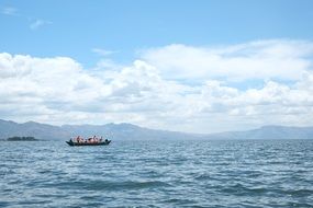 remote view of a boat on a mountain lake erhai