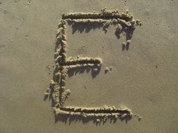 letter E in the sand