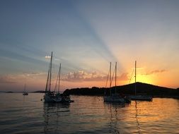 yachts at sea, sunset