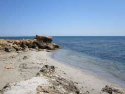 panorama of boulders on a summer beach on the island of Sicily