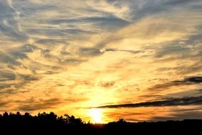 yellow sunrise in the clouds in summer