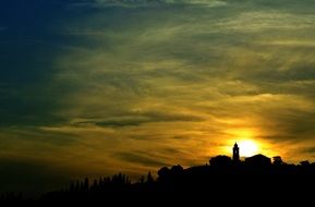 photo of the bright golden sun above the bell tower