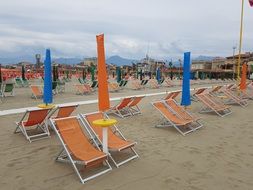 sun loungers and multicolored parasols on the beach in Viareggio, Italy