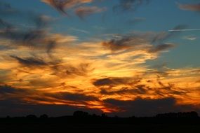 orange sunset behind the clouds