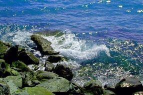 large boulders by the blue ocean