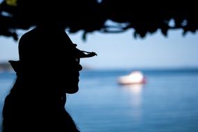 portrait of silhouette of a girl in a hat on a coast in Brazil