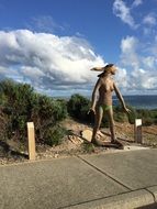 wooden female sculpture on a beach in Australiaa