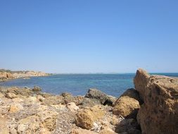 stones on the coast in sicily on a sunny day