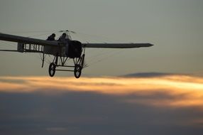 a plane with a propeller in the evening sky
