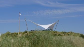 landscape of tent on a green dune