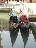 two gondolas in the water channel of venice
