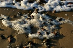 foam on the stones on the beach