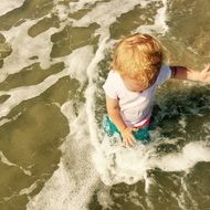 Kid splashing on sea