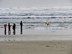 launching kite on the ocean beach