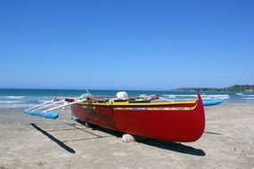 red fishing boat on the coast