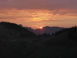 distant sunset view over the alps in tyrol