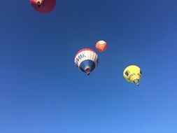colorful hot air balloons in flight in the blue sky