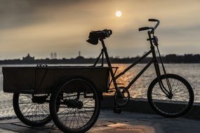 Tricycle under the colorful sunset in the dusk