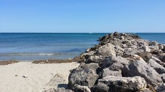 stones on a sandy beach on a sunny day